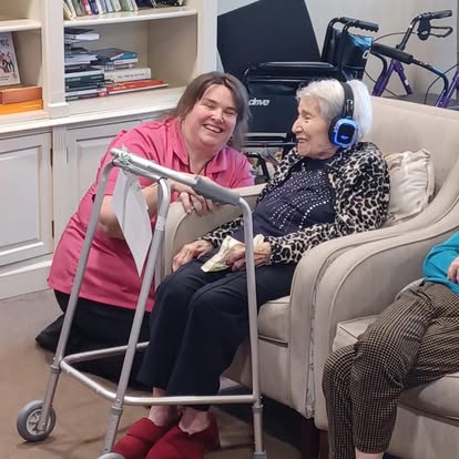 Severn Physiotherapy therapist sharing a laugh with a care home resident wearing silent disco headphones